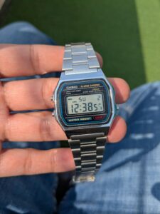 Close-up of a classic Casio digital watch held in hand, showcasing retro style.